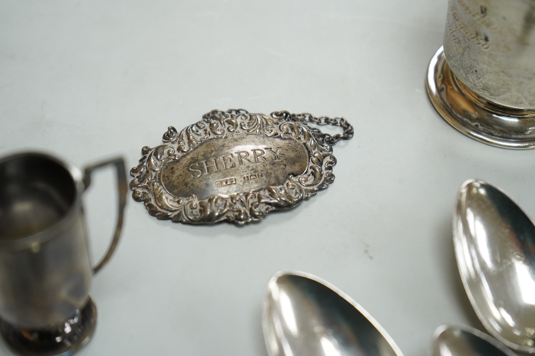 A collection of silver to include a set of six George IV silver Kings pattern teaspoons, by William Eaton, London 1824/5, five other items of silver flatware, a small trophy cup, christening mug and wine label, 13oz.